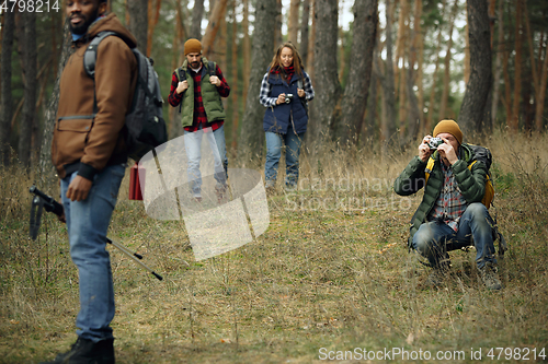 Image of Group of friends on a camping or hiking trip in autumn day