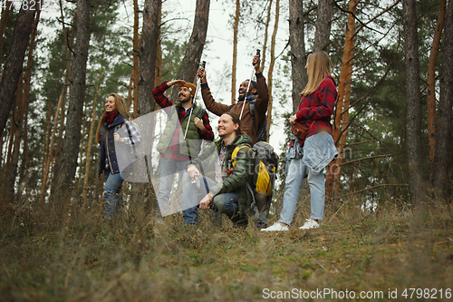 Image of Group of friends on a camping or hiking trip in autumn day