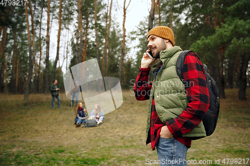 Image of Group of friends on a camping or hiking trip in autumn day