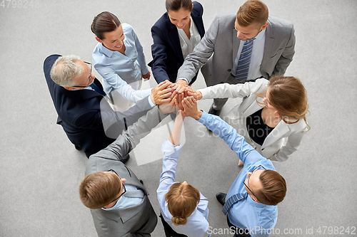 Image of business people making high five in office