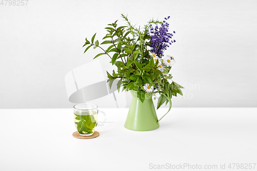 Image of herbal tea and flowers in jug