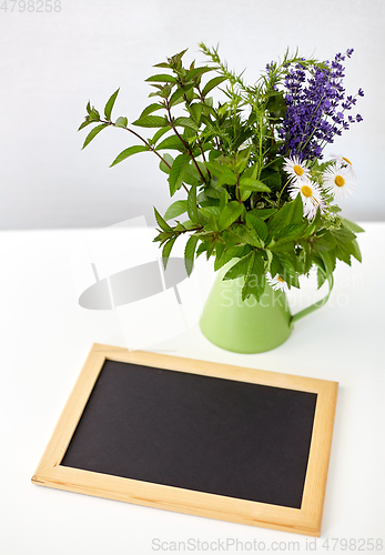 Image of bunch of herbs and flowers with chalkboard