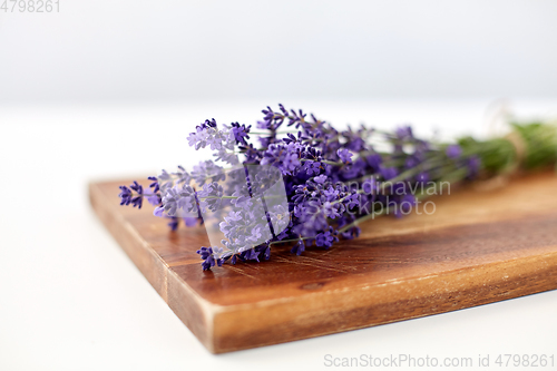 Image of bunch of lavender flowers on wooden board