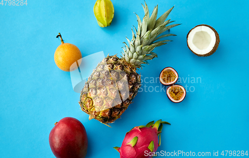 Image of pineapple with other fruits on blue background