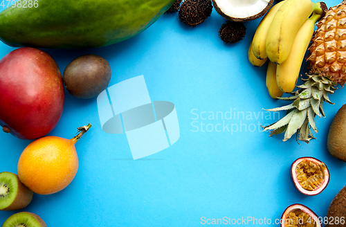 Image of different exotic fruits on blue background