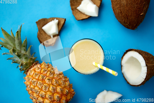 Image of pineapple, coconut and drink with paper straw