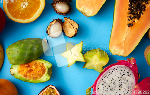 Image of different exotic fruits on blue background