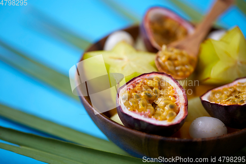 Image of close up of of exotic fruits mix with wooden spoon