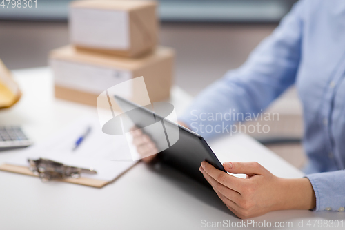 Image of close up of woman with tablet pc at post office
