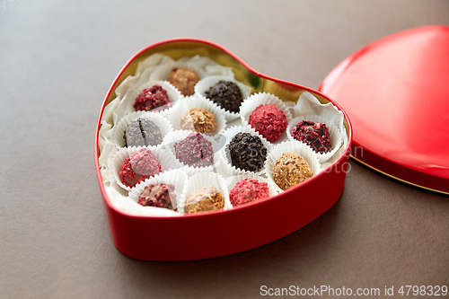 Image of candies in red heart shaped chocolate box