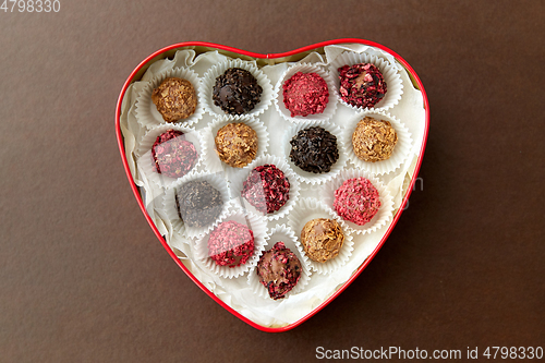 Image of candies in red heart shaped chocolate box