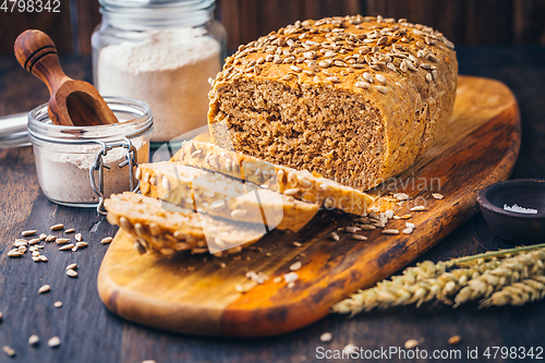 Image of Homemade wholemeal spelt bread with sunflower seeds and baking ingredients
