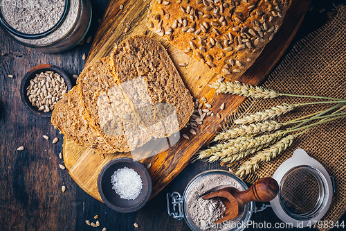 Image of Homemade wholemeal spelt bread with sunflower seeds and baking ingredients