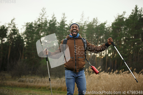 Image of Young man on a camping or hiking trip in autumn day