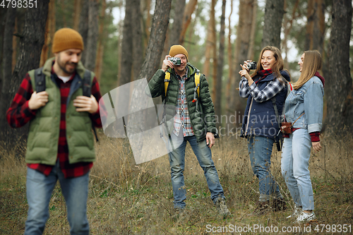 Image of Group of friends on a camping or hiking trip in autumn day