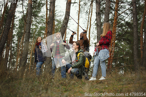 Image of Group of friends on a camping or hiking trip in autumn day