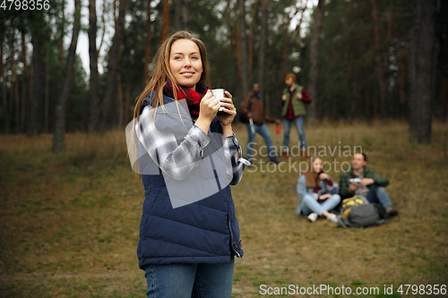 Image of Group of friends on a camping or hiking trip in autumn day