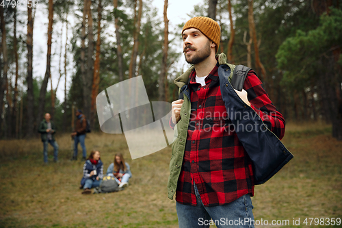 Image of Group of friends on a camping or hiking trip in autumn day