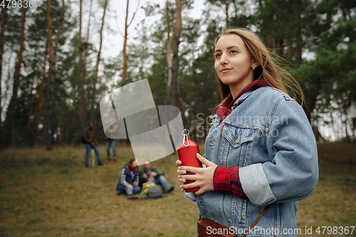 Image of Group of friends on a camping or hiking trip in autumn day