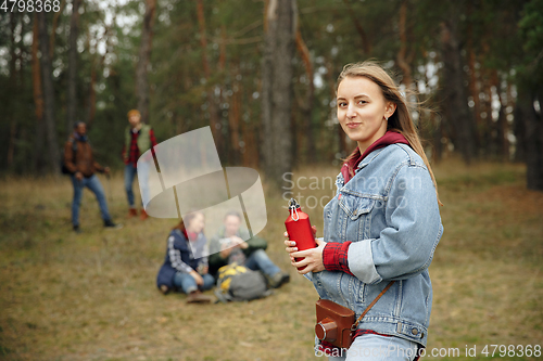 Image of Group of friends on a camping or hiking trip in autumn day