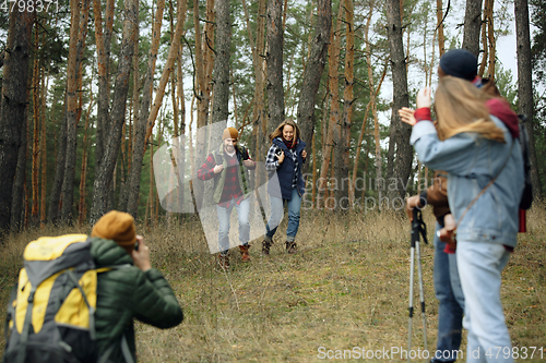 Image of Group of friends on a camping or hiking trip in autumn day