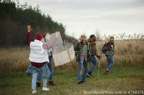 Image of Group of friends on a camping or hiking trip in autumn day