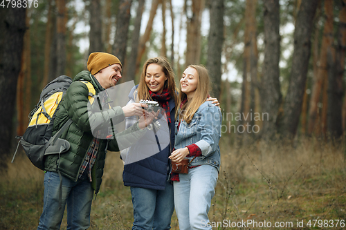 Image of Group of friends on a camping or hiking trip in autumn day