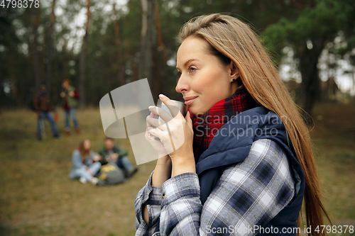 Image of Group of friends on a camping or hiking trip in autumn day