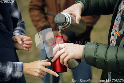 Image of Group of friends on a camping or hiking trip in autumn day