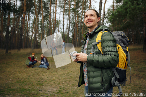 Image of Group of friends on a camping or hiking trip in autumn day