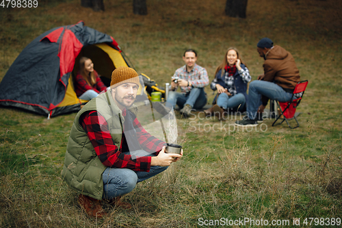 Image of Group of friends on a camping or hiking trip in autumn day