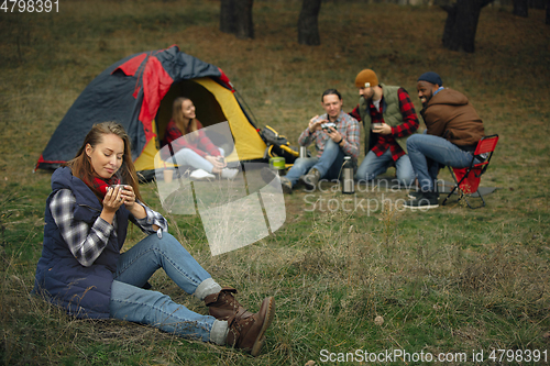 Image of Group of friends on a camping or hiking trip in autumn day