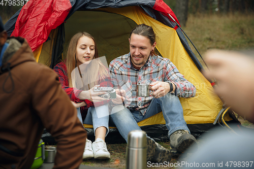 Image of Group of friends on a camping or hiking trip in autumn day