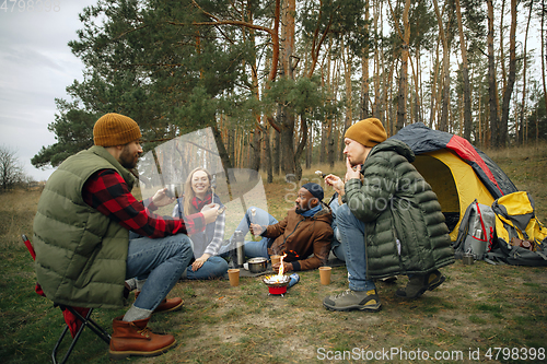 Image of Group of friends on a camping or hiking trip in autumn day