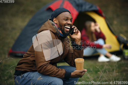 Image of Group of friends on a camping or hiking trip in autumn day