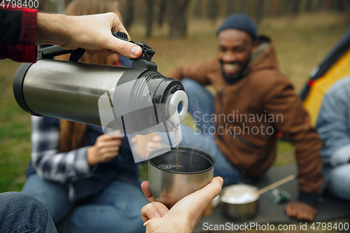 Image of Group of friends on a camping or hiking trip in autumn day