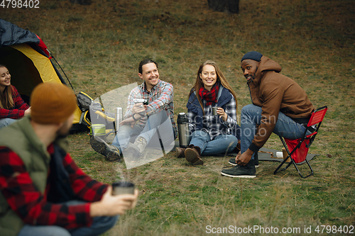 Image of Group of friends on a camping or hiking trip in autumn day