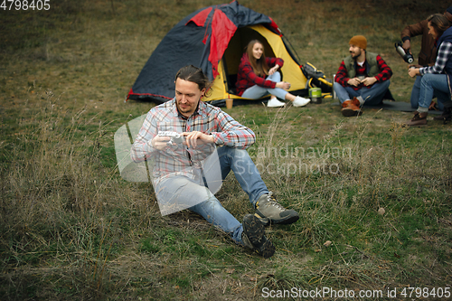 Image of Group of friends on a camping or hiking trip in autumn day