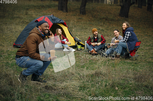 Image of Group of friends on a camping or hiking trip in autumn day