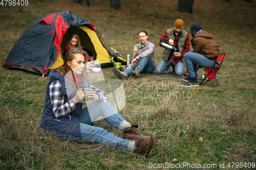 Image of Group of friends on a camping or hiking trip in autumn day