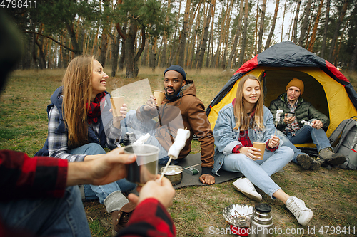 Image of Group of friends on a camping or hiking trip in autumn day