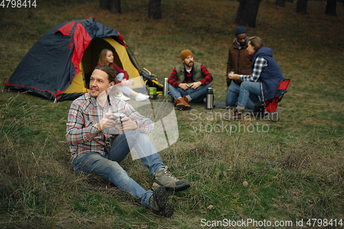 Image of Group of friends on a camping or hiking trip in autumn day