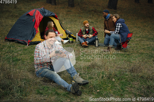 Image of Group of friends on a camping or hiking trip in autumn day