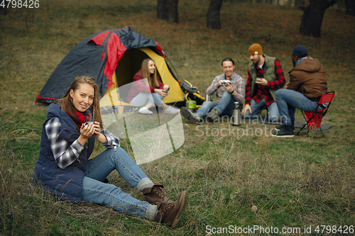 Image of Group of friends on a camping or hiking trip in autumn day