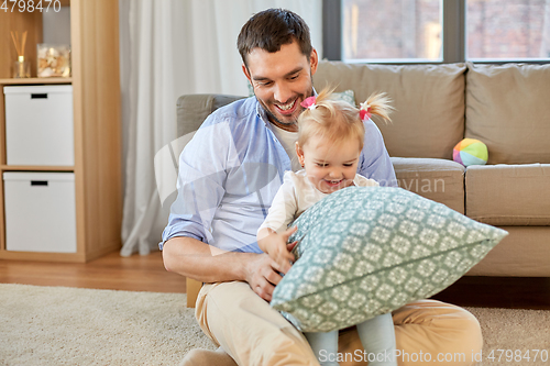 Image of father with little baby daughter at home