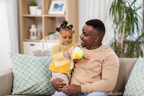 Image of happy african american father with baby at home