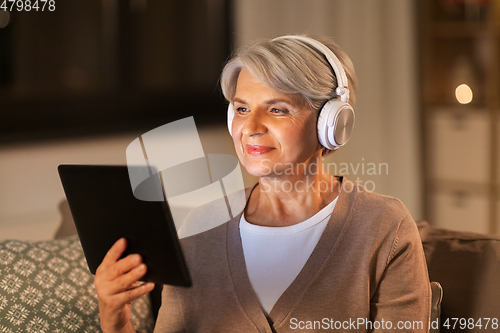 Image of senior woman in headphones listening to music