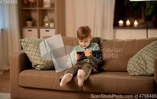 Image of happy little boy with tablet computer at home