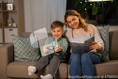 Image of happy mother with little son spending time at home