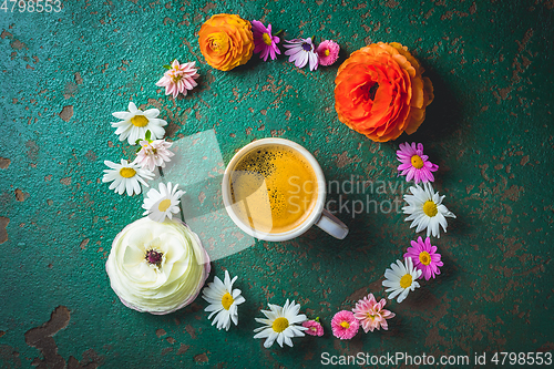 Image of Cup of coffee with variation of flowers on green background